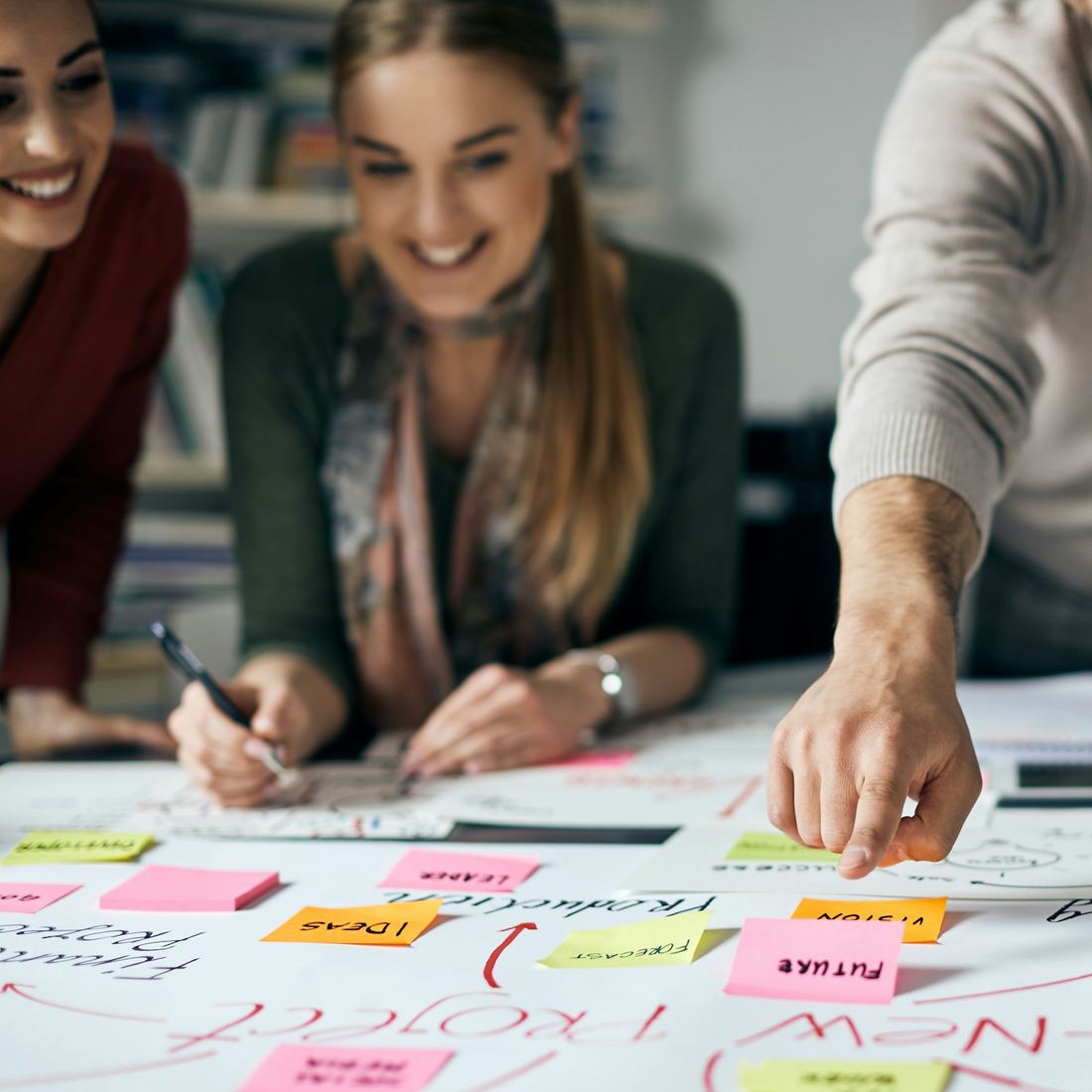 Colleagues working through a plan together at a table
